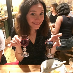 Claire holding two small glasses of vegan red wine - Cheers!